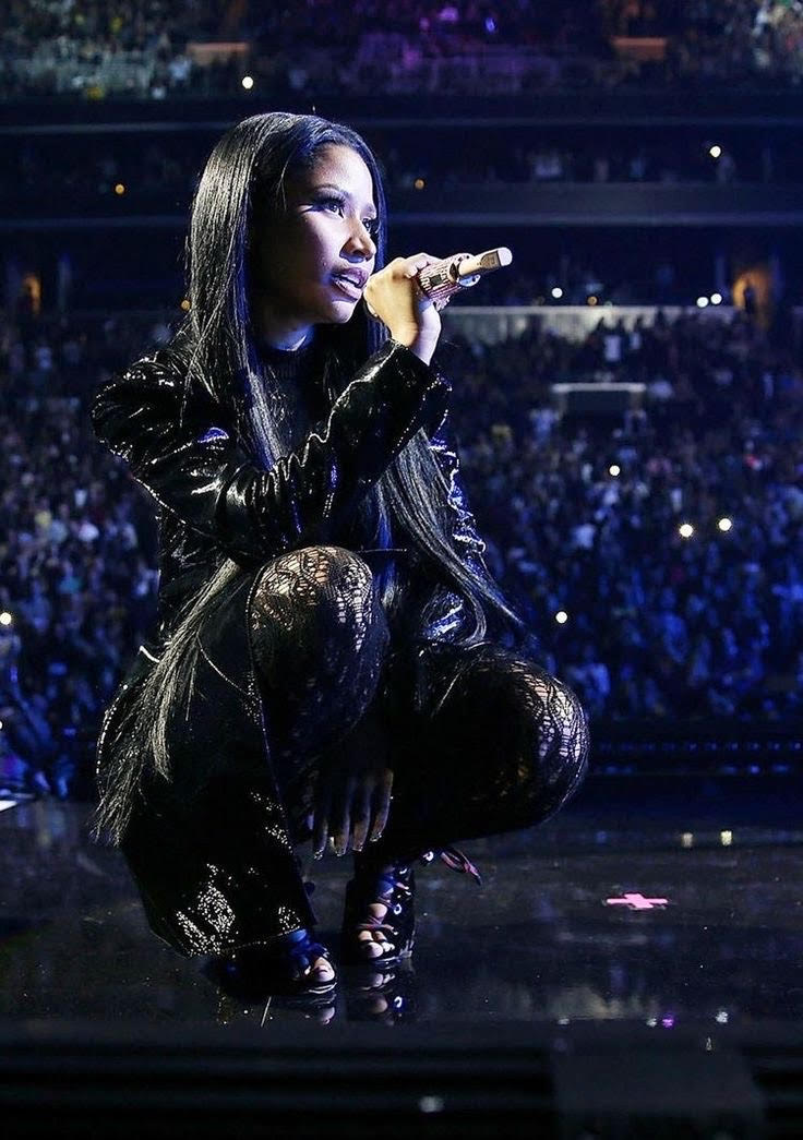 Nicki Minaj crouching onstage during a performance